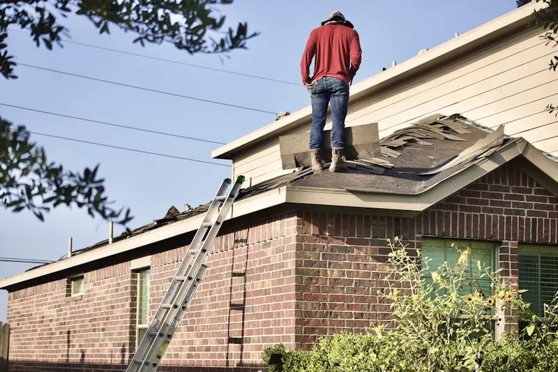 Professional roofer working on a residential roof in Lecompton